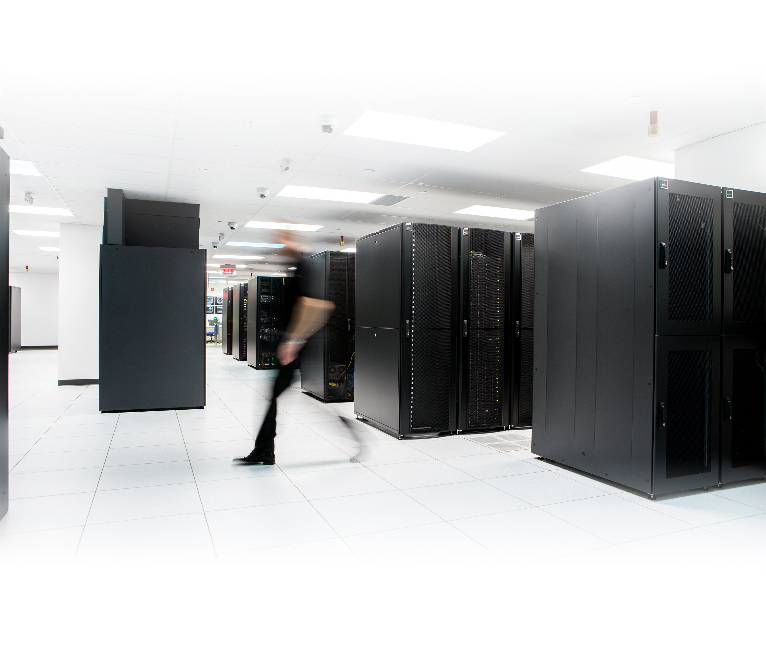 Several rows of black server rack cages in MTL-3, the eStruxture Tier II Certified Montreal data center at 1350 Nobel St.