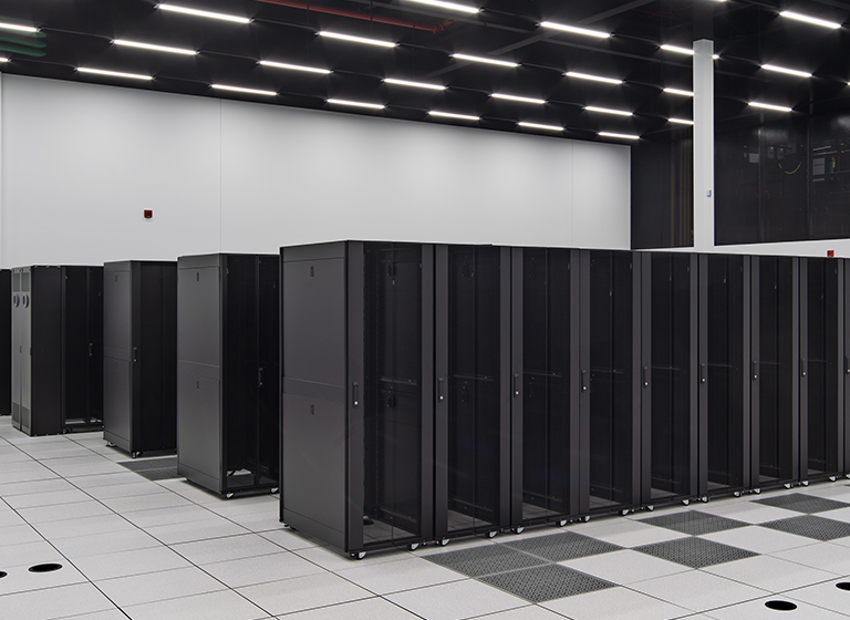 Several rows of black server rack cages in VAN-3, the eStruxture purpose-built Vancouver data center at 4590 Canada Way.