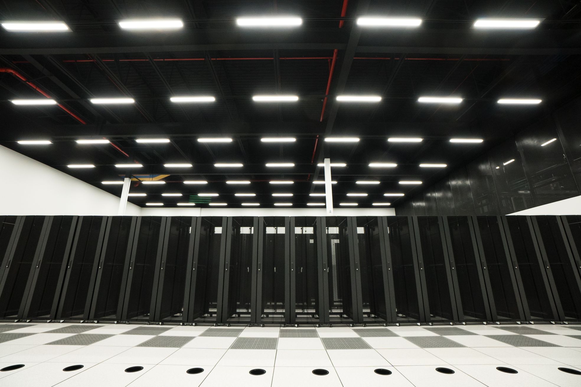 A row of black server racks. Found in MTL-4 - our Kirkland Montreal data center at 17500 Trans-Canada Highway.
